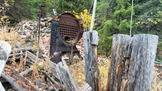 Remnants of a stamp mill briefly used to process ore from the Highland Chief Mine that operated within yards of the Yellowstone Park northern boundary from 1894 to 1908. Fine mine tailings likely eroded soil and washed into Yellowstone National Park via the Yellowstone River. (William Campbell/Greater Yellowstone Coalition)