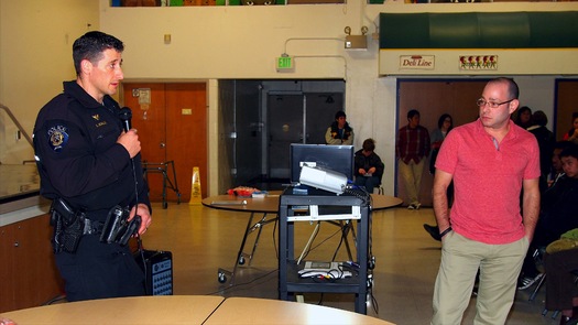 PHOTO: Officer Briggs Schulz, left, of the Federal Way Police Department shares his views with a group of high school students in a 