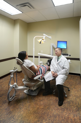 PHOTO: Dr. Tom Plamondon, a retired U.S. Air Force colonel, sees a dental patient at a Peak Vista Community Health Center. Colorado's Peak Vista is participating in a national outreach campaign to hire veterans. Photo courtesy Peak Vista Community Health Centers.