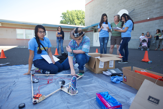 PHOTO: Student Sarai Lopez works with Whitman College astronomy professor Andrea Dobson to prepare a high altitude weather balloon for its inaugural launch. In the background, students Cynthia Montalvo and Cynthia Macias talk with Garrison Middle School science teacher Sue Parrish. Photo courtesy of FORWARD Space Project.
