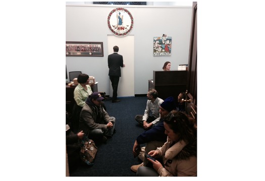 PHOTO: Immigration activists await the arrival of Capitol Hill police in the office of Virginia congresswoman Barbara Comstock. Photo credit: Julie Karant.
