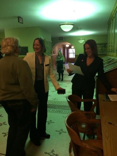 PHOTO: Glenna DeJong and Marsha Caspar, shown here with Ingham County Clerk Barbara Byrum on their wedding day, were the first same-sex couple in Michigan history to legally wed. They will celebrate their first anniversary this weekend by continuing to fight for marriage equality in the state. Photo courtesy of B. Byrum.