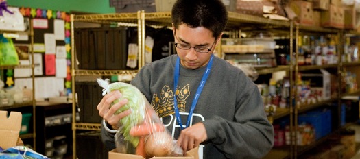 PHOTO: A volunteer at a Share Our Selves food bank is part of the integrated care approach at many California community health centers. Photo courtesy of Share Our Selves.