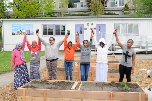 PHOTO: Members of the Green Plate Special club celebrate the addition of raised garden beds to their school's STEM program. Photo credit: Marissa Rousselle.