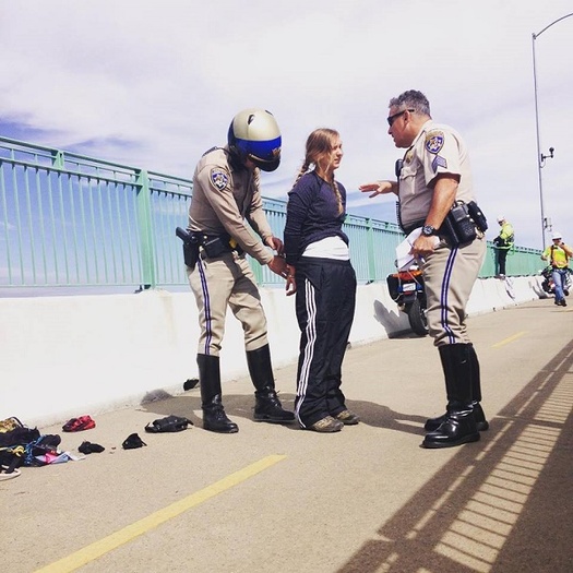 Activist Emily Heffling of the group ForestEthics is detained Monday for trying to hang an anti-oil train banner on the Benicia-Martinez railroad bridge east of Vallejo. Credit: Jay Carmona/ForestEthics.