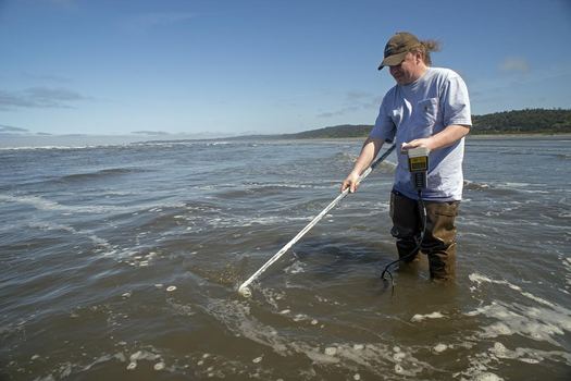 Scott Mazzone, a marine biologist with the Quinault Indian Nation, takes water quality samples. Credit: Debbie Ross-Preston, NW Indian Fisheries Commission.