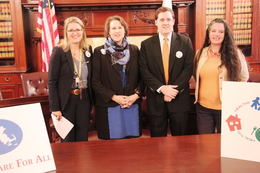 Supporters join Rep. Jay Livingstone, D-Boston, second from right, as lawmakers hold a hearing on a new measure to improve the well-being of hundreds of thousands of children in the Commonwealth. Courtesy: Health Care For All