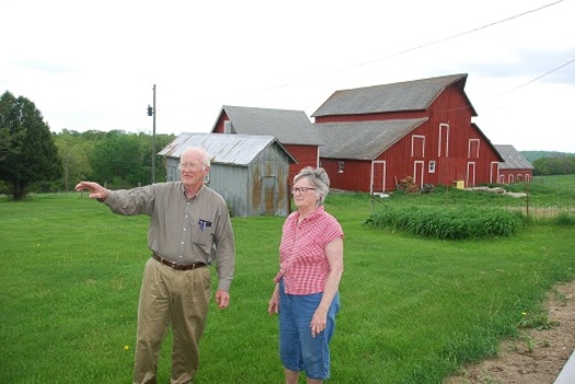 Dale Nimrod shows his wife Sonya around the family farm in southwest Iowa. He and his siblings recently sold the land to help a young couple establish their own family farm. (Practical Farmers of Iowa)