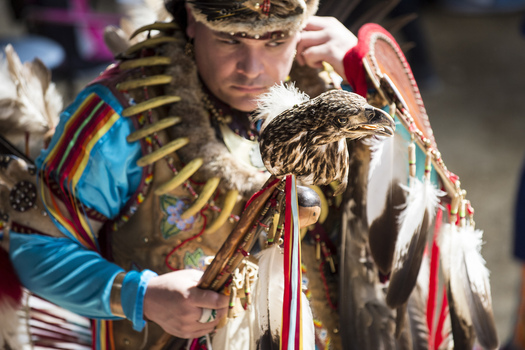 Dancer Joe Syrette of the Ojibwe tribe from Batchewana, Ontario, holds an eagle head staff during the Spring Powwow held on the UW-Madison campus last year. (Jeff Miller/UW-Madison Communications)