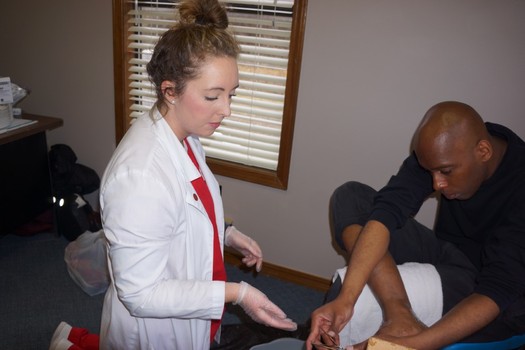 Nursing students teach proper foot care to patients in homeless shelters in Fayetteville. (Eleanor Mann School of Nursing)