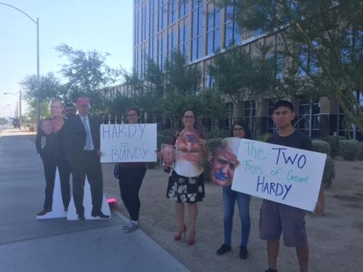 Protesters from Next Gen Climate equate Rep. Cresent Hardy, R-Nev., with Donald Trump and Cliven Bundy outside a hearing on public-lands management in North Las Vegas on Tuesday. (Next Gen Climate)