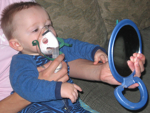 Research says 27,000 childhood asthma attacks occur in Illinois, just over the summer months, due to air pollution from oil and gas operations. (mrplough/Flickr)