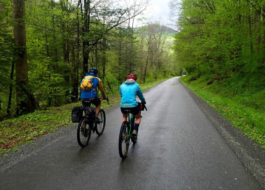 Tourists bike on the Williams River Road after flood damage repairs. Supporters of a new Birthplace of Rivers National Monument say it should help the area recover from this summer's storms. (Matt Kearns)