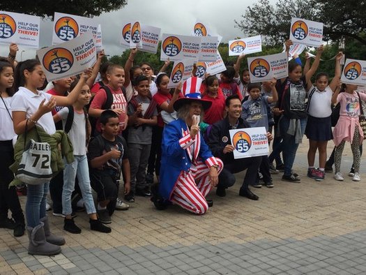 Dressed as Uncle Sam, Andrew Tonkovich, a lecturer in writing, poses with schoolchildren and Mayor Bao Nguyen of Garden Grove at a Prop 55 event at UC-Irvine on Monday. (Fred Glass/California Federation of Teachers)