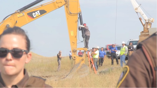 Happi American Horse chains himself to construction equipment at an August protest of the Dakota Access Pipeline. (Desiree Kane/Wikimedia Commons)