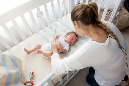 New guidelines say parents should put infants to sleep on their backs in an uncluttered crib. (artfoliophoto/iStockphoto)