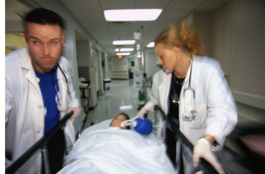 Doctors rush a patient to care. Enrollment for coverage under the Affordable Care Act ends at midnight today. (JillK61)