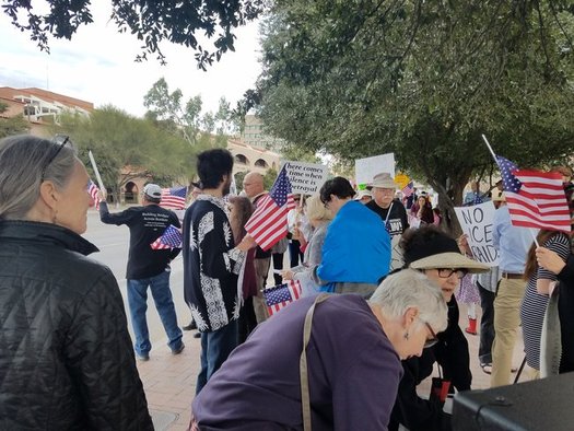 Protesters sang patriotic songs in front of Sen. John McCain's office in Tucson to protest immigration raids. (Indivisible Southern Arizona)