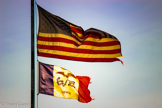 The U.S. Flag Code says the American flag should always be the highest in a series of flag poles, or on the same pole as another flag. (Evan Guest/Flickr)