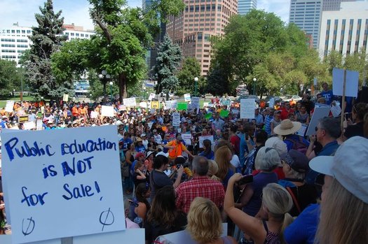 Hundreds gathered at the Colorado State Capitol to protest U.S. Secretary of Education Betsy DeVos' appearance at last week's American Legislative Exchange Council meeting. (Caroline Fry)