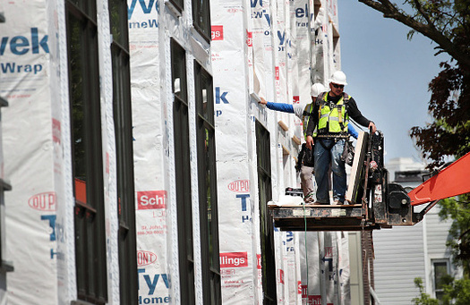 Construction workers put the finishing touches on new townhouses in Dallas. The high cost of housing is making it difficult for low-income Texans to find an affordable home. (ScottOlson/Getty Images)