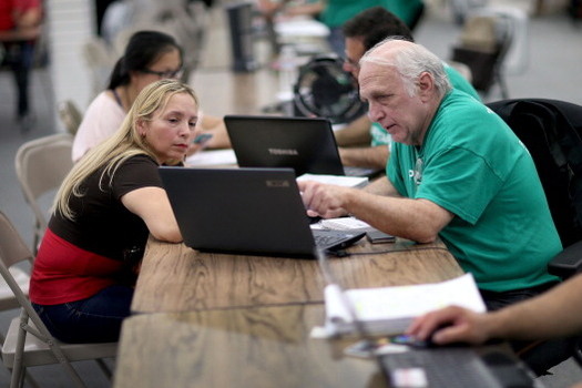As the federal government pulls money out of the Affordable Care Act, its advocates and volunteers are helping to publicize the program and assist people with enrollments. (Raedle/GettyImages) 