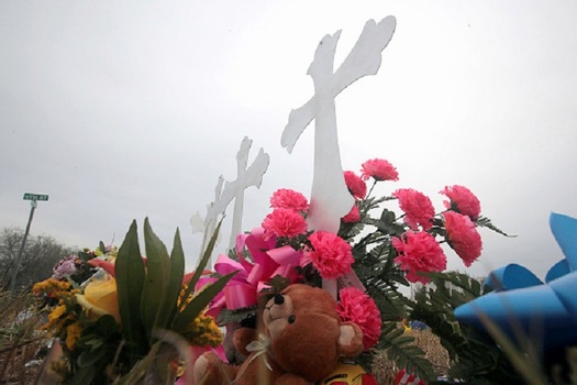A memorial for 26 members of First Baptist Church in Sutherland Springs killed in last Sunday's shooting is set in a field across from the church. (Olsen/GettyImages)