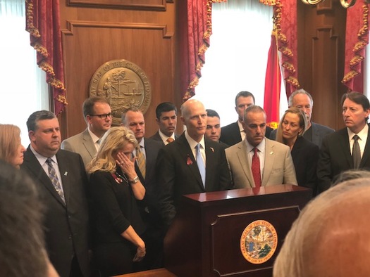 Florida Gov. Rick Scott signs the new gun-control bill into law. (Trimmel Gomes)