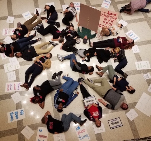 Twenty protesters participate in a Die-In on the fourth-floor rotunda of the Florida State Capitol.  (Lakey Love) 