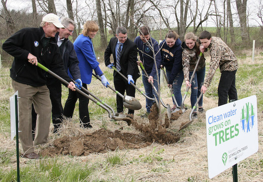 State and federal officials and local high school students joined Chesapeake Bay Foundation president Will Baker in planting the first tree. (B.J. Small/CBF Staff)
