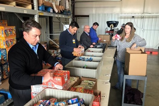 Volunteers help sort products at the Northwest Arkansas Food Bank in the Fayetteville area, one of four regional food banks in the state. (NWArkansasFoodBank)