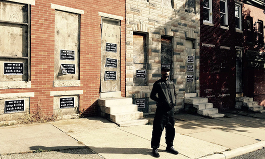 Munir Bahar, 36, founder of COR Health Institute, stands in front of four vacant row homes he reconstructed into a community martial arts and fitness facility dedicated to serving at-risk children living in East Baltimore. (COR Health Institute)