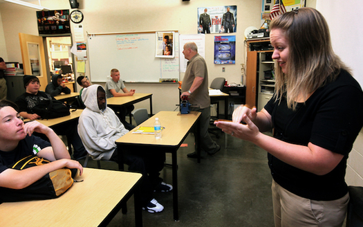 Paraeducators perform a range of tasks to help teachers in the classroom, including signing for students with hearing impairments. (Ellen Banner)