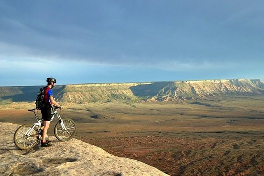 A mountain biker surveys the terrain on the Gooseberry Mesa National Recreation Trail in southern Utah. (Wikimedia Commons)