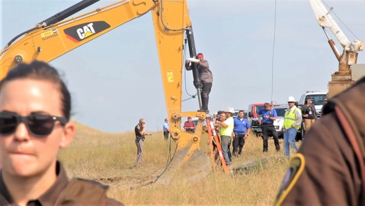 A Lakota man locks himself to construction equipment in 2016 to protest construction of the Dakota Access Pipeline. (en.wikipedia.org) 