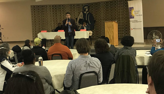 Igor Volsky with the group Guns Down America spoke at a town hall meeting Monday night in Flint. (Sam Inglot/Progress Michigan)