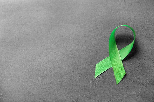 Green ribbons are the symbol for Mental Health Awareness Month. (New Africa/Adobe Stock)