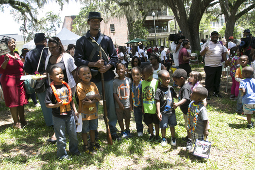 Union soldier re-enactor poses with children during Florida's Emancipation Day Celebration on May 20, 2015, at the Knott House Museum in Tallahassee. (Florida Memory)