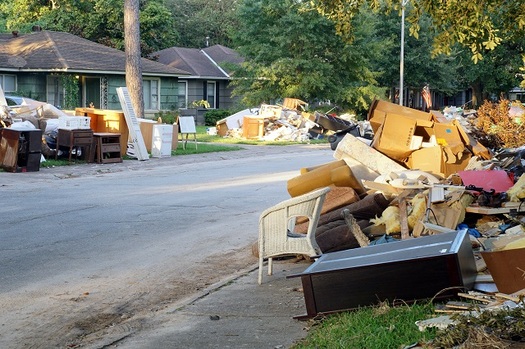 Flood damage debris lines a Houston residential street following Hurricane Harvey in 2017. More than 200,000 homes and businesses along the Texas Gulf Coast were damaged or destroyed by the storm. (IrinaK/AdobeStock)