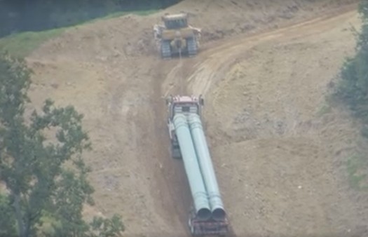 The Mountain Valley Pipeline is being built on slopes so steep that trucks carrying pipe sections sometimes have to be pulled up by bulldozers. (Alan Moore/Virginians Against Pipelines/Facebook)