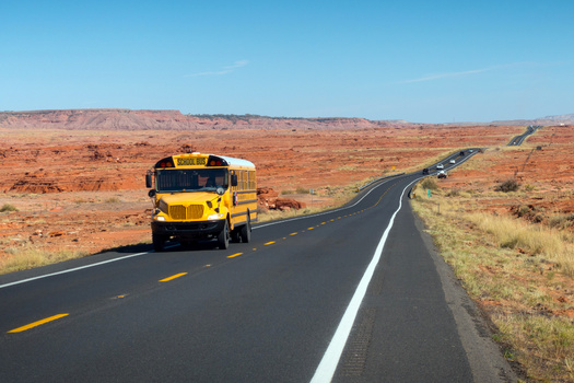 A school bus transports students through the Navajo Nation on U.S. Highway 89 in northern Arizona. Bus routes in rural school districts often cover more than 100 miles a day picking up and dropping off students. (Savola/Adobe Stock)
