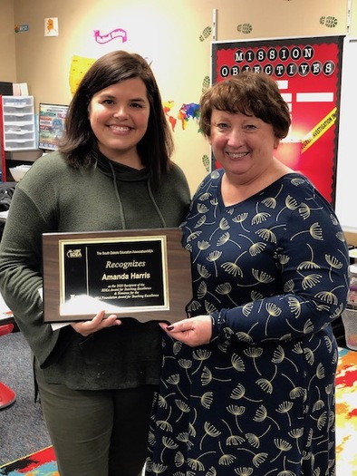 Harrisburg elementary teacher Amanda Harris, left, this week received the 2020 Teacher of Excellence  from South Dakota Education Association President Mary McCorkle. (SDEA)