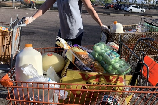 A volunteer helps distribute groceries last week at the Help Yourself Food Co-op, held every Friday in Mesa. It is sponsored by United Food Bank, part of the Arizona Food Bank Network and Feeding America. (United Food Bank photo)