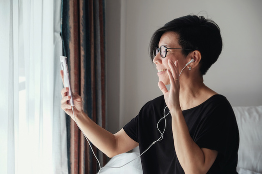 Health professionals say it's important to maintain social connections, such as over the phone, while in isolation from COVID-19. (sewcream/Adobe Stock)