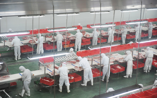 In addition to close distances on the assembly lines, meat plant workers often have to clean up in crowded locker rooms. (Adobe Stock)