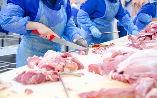In addition to close distances on the assembly lines, meat plant workers often have to clean up in crowded locker rooms. (Adobe Stock)
