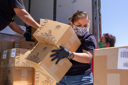 Volunteers unload boxes of water on the Navajo Nation as part of a grassroots food-distribution effort to help the 180,000 tribal members during the coronavirus pandemic. (Deidra Peaches)