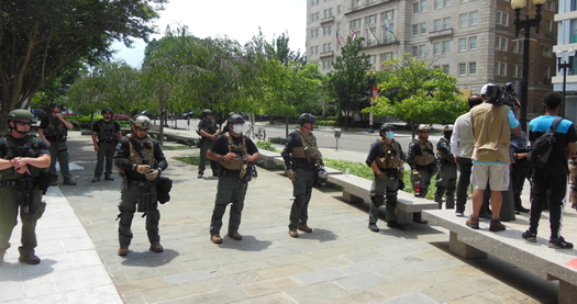 Law enforcement officers with no visible identification wait for protesters in downtown Washington, D.C., on Sat., June 6. (Wikimedia Commons)