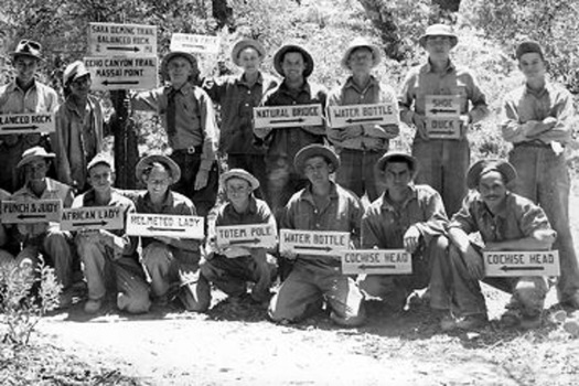 Civilian Conservation Corps workers display the handmade signs they created to post along a newly constructed trail system in 1937 at the Chiricahua National Monument in Arizona. (University of Arizona Library)