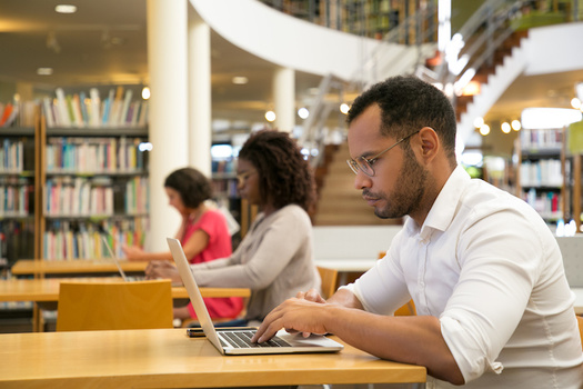 Almost two-thirds of Americans say closing their local library would have a major impact on their community, according to a 2015 Pew survey. (Adobe Stock)